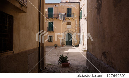 Exploring the charming alleys of Tropea, discovering hidden courtyards and ancient buildings 127660801