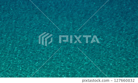 Crystal clear turquoise water surface reflecting sunlight in Tropea, Italy Crystal clear turquoise water surface reflecting sunlight in Tropea, Italy 127660832