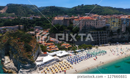 Tropea, Calabria, showing colorful beach umbrellas and turquoise crystalline sea during summer 127660881