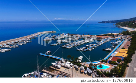 Tropea port with docked boats enjoying summer sunny day in Calabria, Italy 127660916