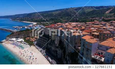 Tropea, Italy, aerial view of cityscape rising on rocky cliff overlooking Tyrrhenian Sea 127661151