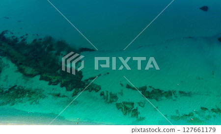 Aerial view of Tropea beach revealing emerald green water and rocks in Calabria, Italy 127661179