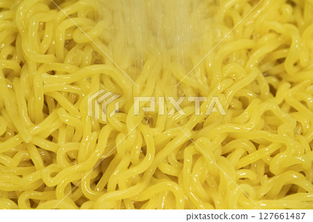 Boiled chilled Chinese noodles being rinsed in cold water (stock photo) 127661487