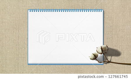 Fluffy cotton flowers and a sketchbook with the background of "Garabo" cotton fabric 127661745