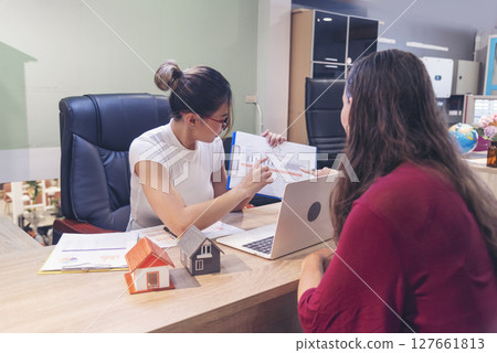 Businesswoman real estate house agent discuss to customer. Team diversity women selling house real estate agent at office desk. Women working home insurance mortgage sale apartment realtor dealership Businesswoman real estate house agent discuss to customer. Team diversity women selling house real estate agent at office desk. Women working home insurance mortgage sale apartment realtor dealership 127661813