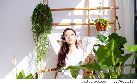 A model bathed in the morning sun in a botanical atmosphere A model bathed in the morning sun in a botanical atmosphere 127662118