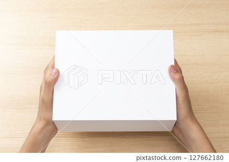 Hand holding a white box Hand holding a white box 127662180