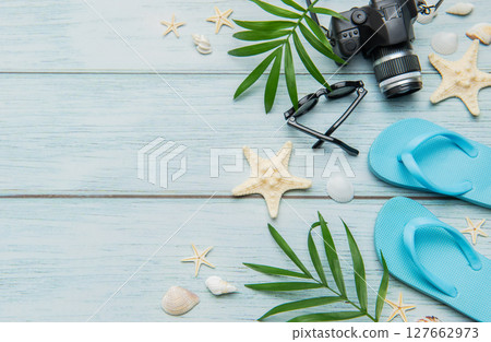 Beach vacation accessories arranged on rustic blue wooden background Beach vacation accessories arranged on rustic blue wooden background 127662973