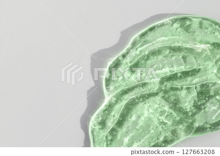Green cosmetic smear gel texture on a white background 127663208
