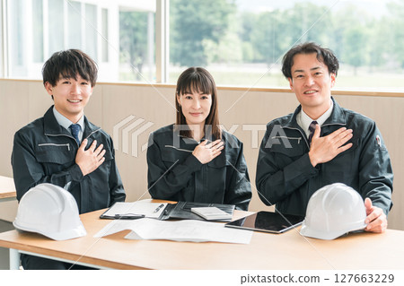 穿著工作服坐在會議室裡，穿著工作服的商人和女人（安心，信任） 127663229