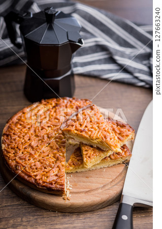 Sweet almond pie on wooden table. 127663240