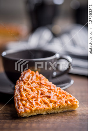 Sweet almond pie on wooden table. 127663241