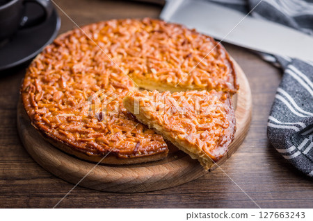 Sweet almond pie on wooden table. 127663243