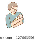 Father smiling while holding a baby 127663556