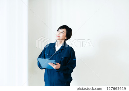 Middle-aged woman in work clothes Middle-aged woman in work clothes 127663619