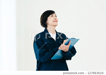Middle-aged woman in work clothes Middle-aged woman in work clothes 127663628