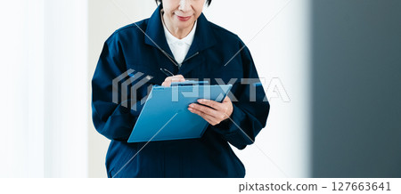 Middle-aged woman in work clothes 127663641