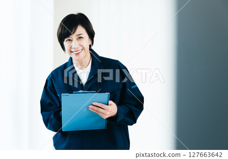 Middle-aged woman in work clothes 127663642
