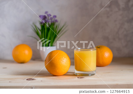 Orange reflects natural light on the kitchen table 127664915