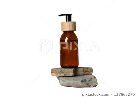 Amber bottle resting on two stacked stones, isolated on white, PNG Amber bottle resting on two stacked stones, isolated on white, PNG 127665270