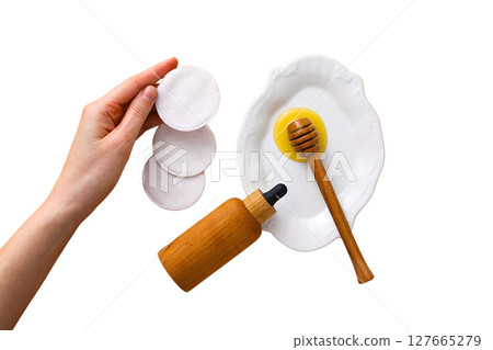 Hand with cotton pads, honey, egg, isolated on white, PNG 127665279