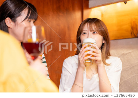 Women drinking at a girls' party Women drinking at a girls' party 127665480