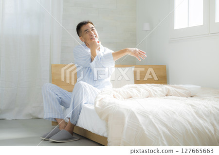 Senior man waking up in good spirits in his bedroom 127665663