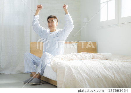 Senior man waking up in good spirits in his bedroom 127665664