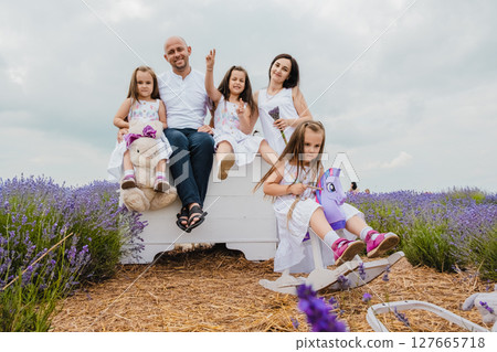 The parents and children relax in the lavender field The parents and children relax in the lavender field 127665718