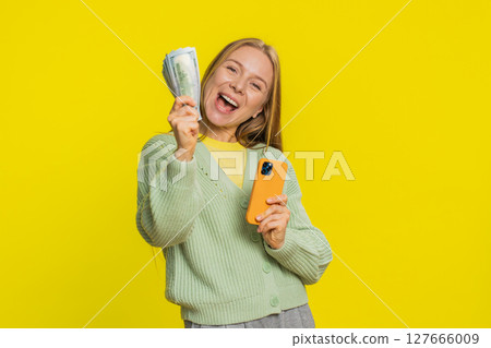 Happy woman use smartphone rejoicing game win, receiving money dollar cash, celebrating success Happy woman use smartphone rejoicing game win, receiving money dollar cash, celebrating success 127666009