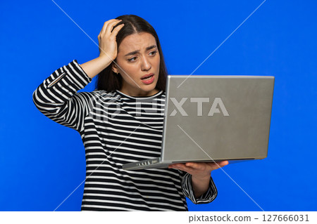 Displeased woman use laptop surprised by bad news, fortune loss, play game fail, lottery results 127666031