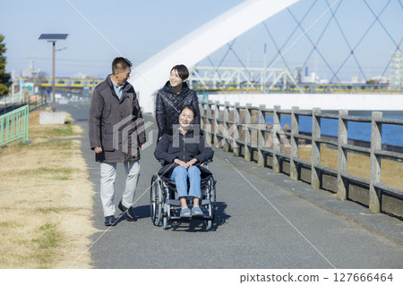 Woman in wheelchair and family 127666464