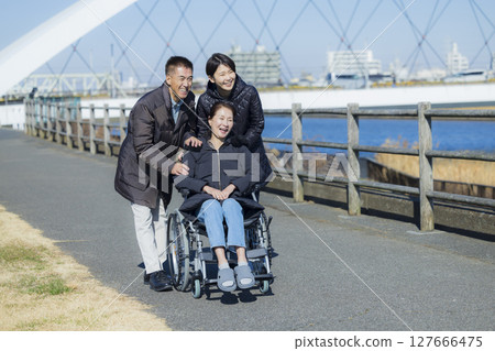 Woman in wheelchair and family 127666475