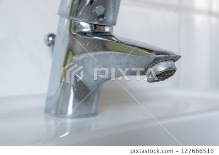 Water dripping of lime on metal tap. Durty faucet in bathroom. Water dripping of lime on metal tap. Durty faucet in bathroom. 127666516
