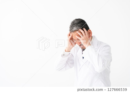 Man in white coat, portrait, holding head Man in white coat, portrait, holding head 127666539