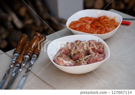 Raw Marinated Chicken and Lamb Meat Prepared for Kebabs with Skewers, Wooden Handles, Outdoor Setting, Red and Pink Hues, Rustic Texture Raw Marinated Chicken and Lamb Meat Prepared for Kebabs with Skewers, Wooden Handles, Outdoor Setting, Red and Pink Hues, Rustic Texture 127667114