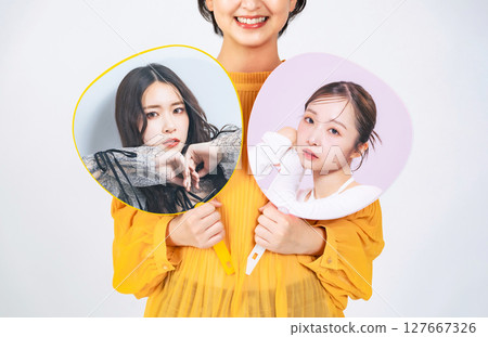 A female fan holding a fan of her favorite idol 127667326