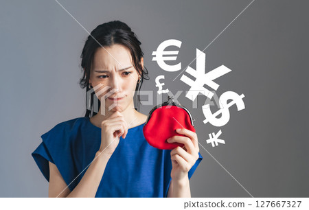 A woman worried about money while looking at her wallet 127667327