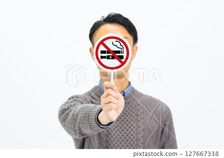 Middle-aged man holding a no smoking sign 127667338
