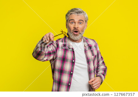 Magician witch Caucasian man gesturing with magic wand making wish come true, casting magician spell 127667357