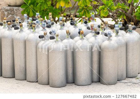 Aluminum scuba diving oxygen tanks in the beach 127667482