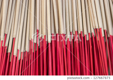 Background of beige incense sticks with red holders Background of beige incense sticks with red holders 127667873