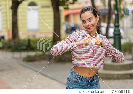 Caucasian woman makes symbol of love showing heart sign to camera express romantic feelings, charity Caucasian woman makes symbol of love showing heart sign to camera express romantic feelings, charity 127668118