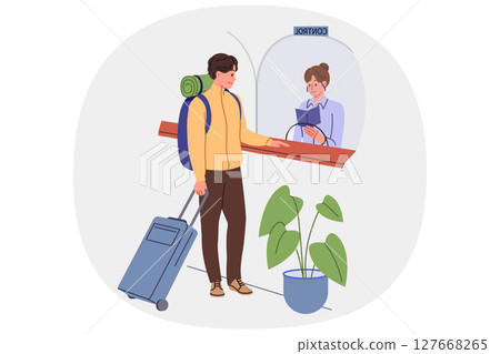 Man goes through passport control at airport crossing state border, showing documents to controller 127668265