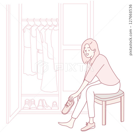A Woman Enjoys Trying on Shoes in a Cozy and Inviting Closet Setting filled with Style A Woman Enjoys Trying on Shoes in a Cozy and Inviting Closet Setting filled with Style 127668536