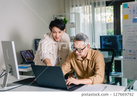 Group of asian senior in a collaborative software development analyzing  flowcharts  during a bootcamp training 127669792