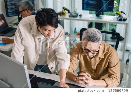 Group of asian senior in a collaborative software development analyzing  flowcharts  during a bootcamp training 127669799