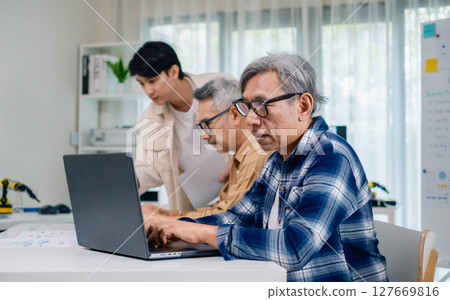 Group of asian senior in a collaborative software development analyzing  flowcharts  during a bootcamp training 127669816