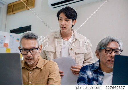 Asian Instructor Teaching Senior in Software Programming and Training Collaboration Asian Instructor Teaching Senior in Software Programming and Training Collaboration 127669817