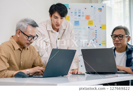 Asian Instructor Teaching Senior in Software Programming and Training Collaboration Asian Instructor Teaching Senior in Software Programming and Training Collaboration 127669822